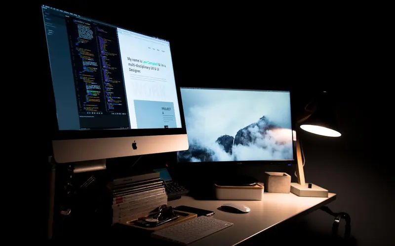Website design open on a desktop and monitor